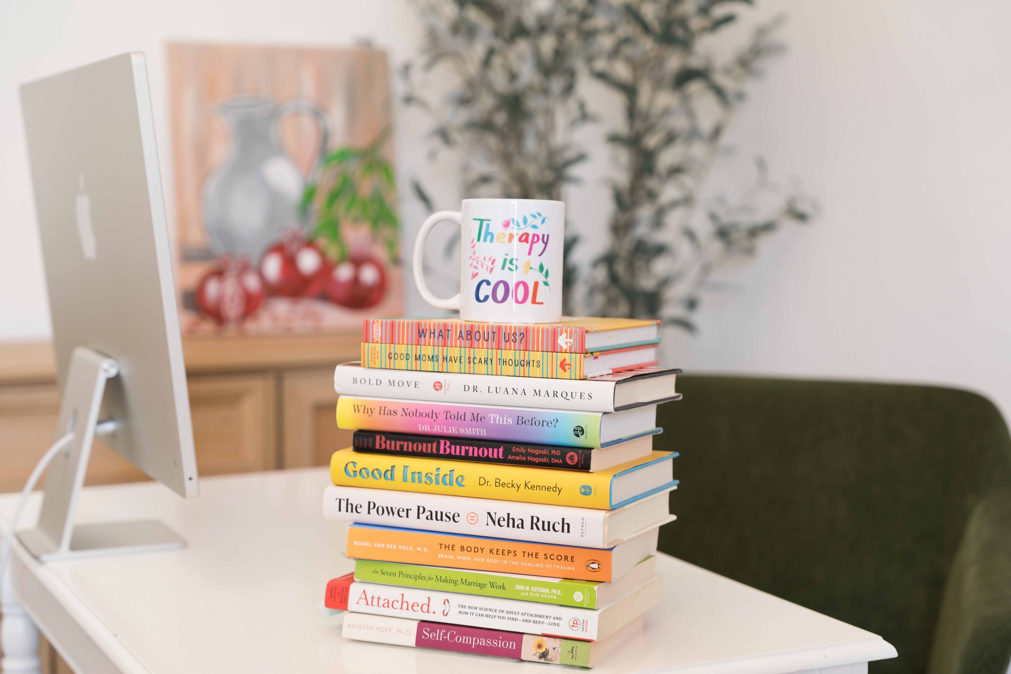 Therapy books and a mug on Amalya's desk